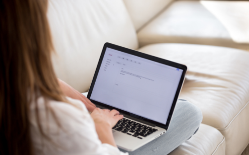 Girl Typing Cover Letter for MIT Sloan