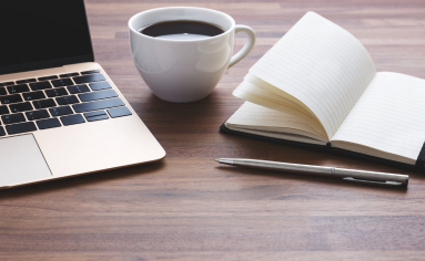 a desk with the tools to write the Top MBA Essays